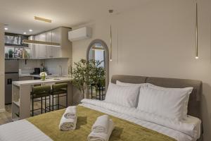 a bedroom with a large bed and a kitchen at Moon Apartments in Cluj-Napoca
