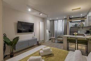 a living room with a bed and a kitchen at Moon Apartments in Cluj-Napoca +68 photos
