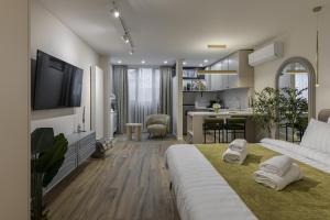 a living room with a bed and a kitchen at Moon Apartments in Cluj-Napoca