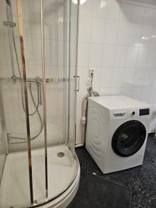 a washing machine sitting on a toilet in a bathroom at Leilighet Vingnes in Lillehammer +17 photos
