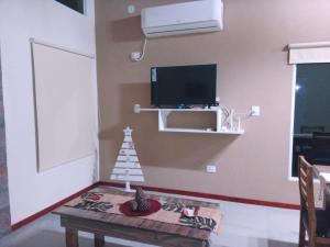 a living room with a table and a tv and a table sidx sidx at Pinares del Norte in Federación