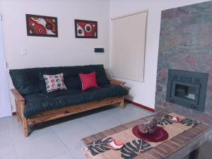 a living room with a couch and a fireplace at Pinares del Norte in Federación