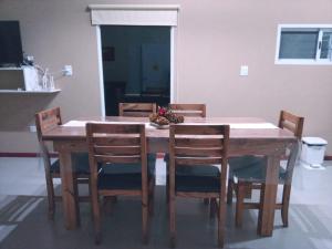 a wooden table and chairs with a bowl of fruit on it at Pinares del Norte in Federación +17 photos