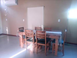 a dining room with a wooden table and chairs at Pinares del Norte in Federación
