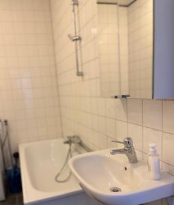 a bathroom with a sink and a bath tub at Helsingebockens Fastigheter in Bollnäs +28 photos
