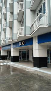 a building with a bdo sign on the side of it at Nygel Staycation at Shell Residences in Sampong