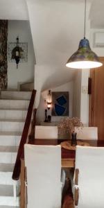a dining room with a table and white chairs at Seaside Green Villa in Karianí +30 photos