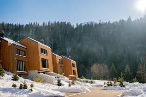 a building with snow in front of a mountain at Mountain Retreat by Dukley in Kolašin
