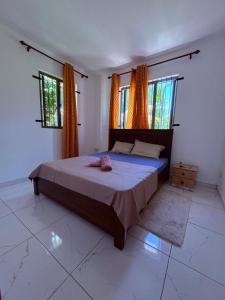 a bedroom with a bed and two windows at Cool Breeze Villa No 2 in Grand-Baie +36 photos