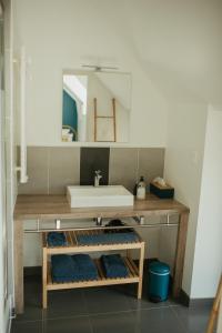 a bathroom with a sink and a mirror at Parenthèse in Le Vivier-sur-Mer +55 photos