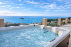 a hot tub on a balcony with a view of the ocean at Villa Blue Vista Meerblick mit Jacuzzi in Petrovac na Moru +37 photos