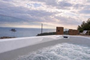 a bath tub with a view of the ocean at Villa Blue Vista Meerblick mit Jacuzzi in Petrovac na Moru