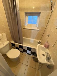 a small bathroom with a toilet and a sink at Cosy room 4 T Gatwick in Crawley +5 photos