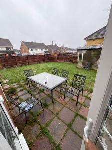a table and chairs in a yard with a field at Cosy room 4 T Gatwick in Crawley