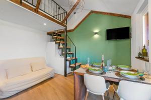 a living room with a table and a couch at La Chicchetta - Happy Rentals in Sauze d'Oulx