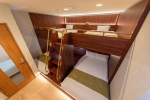 a small cabin with two bunk beds in it at Kawasaki Central House in Kawasaki