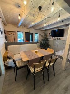 a dining room with a wooden table and chairs at Шале 1077 метрів над рівнем моря in Krivopolʼye