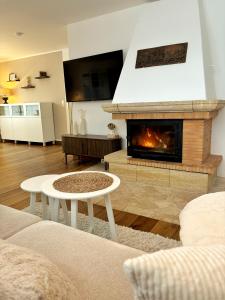 a living room with a fireplace and a couch at Ferienhaus Sandstrand in Cuxhaven