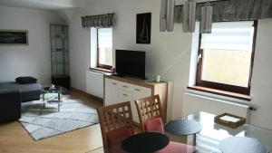 a living room with a television and a table and chairs at Otto in Reding