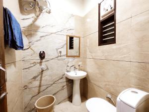 a bathroom with a sink and a toilet at HOTEL THE VELVET PRIME - Premium & Luxury Suits Rooms in Phagwāra