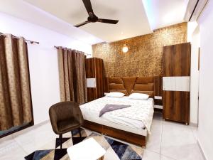 a bedroom with a bed and a chair at HOTEL THE VELVET PRIME - Premium & Luxury Suits Rooms in Phagwāra +18 photos