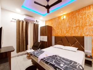 a bedroom with a bed and a ceiling fan at HOTEL THE VELVET PRIME - Premium & Luxury Suits Rooms in Phagwāra