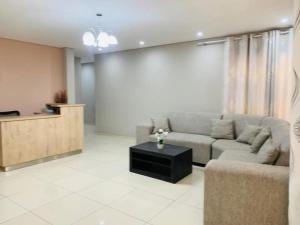 a living room with a couch and a table at Logo Luxury Guesthouse in Windhoek