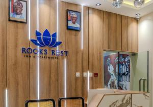 a room with a ross institute sign on the wall at Rooks Rest Inn & Apartments in Lagos