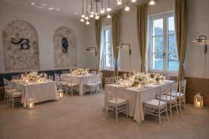 a room with tables and chairs with flowers on them at Santa Boka Small Luxury Hotels of the World in Perast