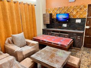 a living room with a couch and a tv at Kejriwals Vaikunth 35A in Bangalore