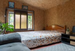 a bedroom with a bed and a large window at Ti kaz gogo in Salazie