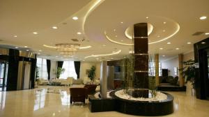 a lobby with a fountain in the middle of a building at Ramada Plaza By Wyndham Kahramanmaras in Kahramanmaraş