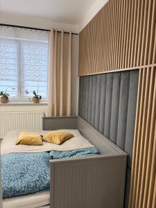 a bed with two pillows on it in a bedroom at Apartament Olesno Lux in Olesno