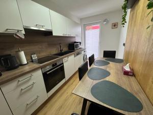 a kitchen with a wooden table with chairs and a tableasteryasteryasteryasteryastery at Apartment Angela in Mittersill