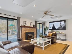 a living room with a couch and a fireplace at Hot Tub with Backyard Play Area in Toronto