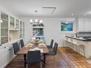 a dining room with a table and chairs in a kitchen at Hot Tub with Backyard Play Area in Toronto