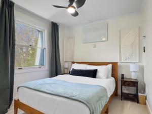 a bedroom with a bed and a window at Hot Tub with Backyard Play Area in Toronto +35 photos