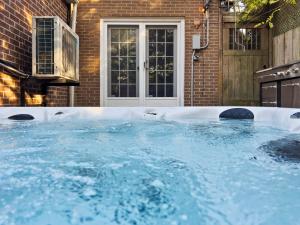 a hot tub in the backyard of a house at Hot Tub with Backyard Play Area in Toronto