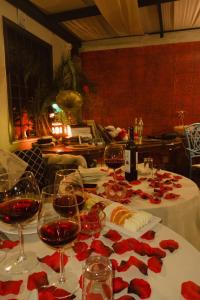 a table with wine glasses and red roses on it at Loost Town Inn Hotel in Antalya