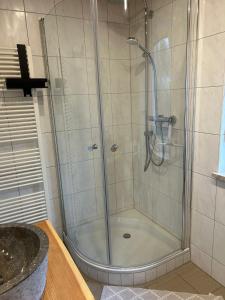 a shower with a glass door in a bathroom at ZweiundMeer Bungalow 2 in Wiek auf Rügen +15 photos