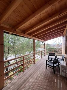a wooden porch with a bench on a deck at Villa Argjiro in Draç