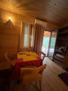 a dining room with a table in a cabin at Villa Argjiro in Draç