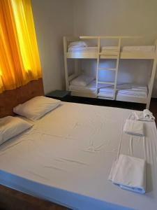 a bedroom with a white bed with a shelf at Villa Argjiro in Draç +5 photos