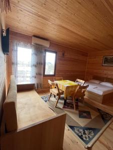a room with a bed and a table and chairs at Villa Argjiro in Draç