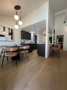a kitchen and living room with a table and chairs at Midland Luxe, Pool, Fire Pit, Workspace, Pool Table in Midland