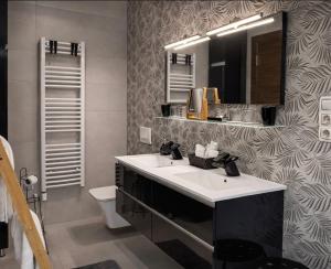 a bathroom with a sink and a mirror and a toilet at Oaza Resnik in Zagreb +5 photos