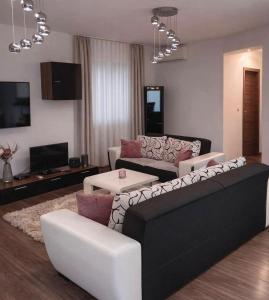 a living room with a black and white couch at Oaza Resnik in Zagreb