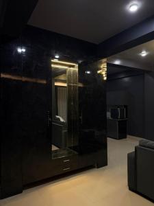 a bathroom with a large mirror in a room at Noir Suites in Patna