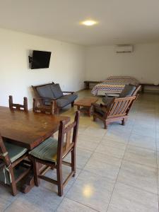 a room with wooden tables and chairs in a room at Quincho Monoambiente Con Parrilla in Balcarce