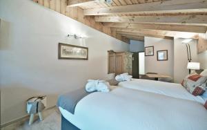 a bedroom with two beds with towels on them at Hôtel Le Chamois in Les Diablerets